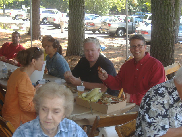 Congressional hopeful John Leo Walter (right, in red) enjoys his lunch with family and friends.